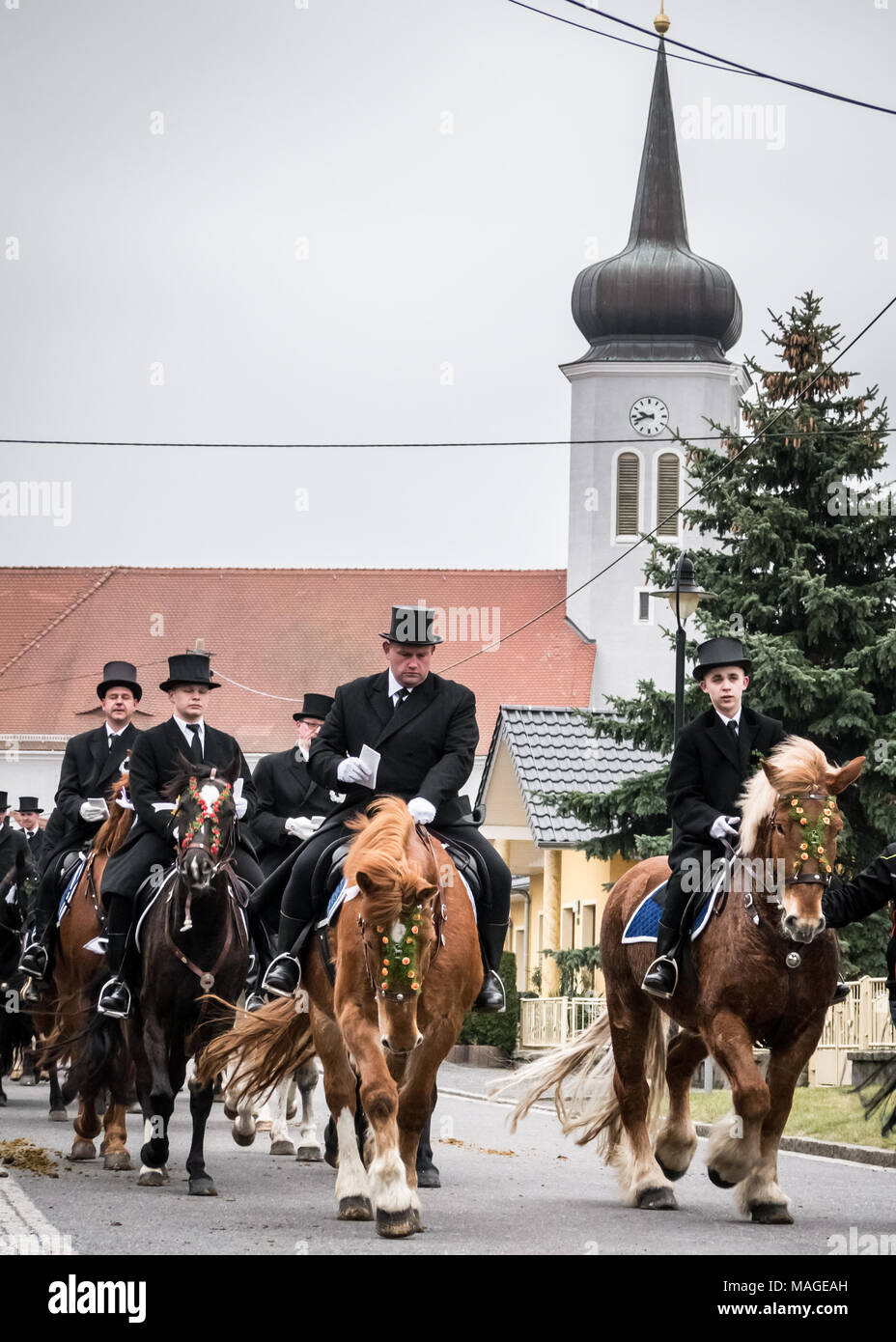 Lausitz, Germany. 1st Apr, 2018. Easter riders (Osterreiter) riding through Ralbitz (with the church in the background) during the Sorbian Easter Procession Credit: Krino/Alamy Live News Stock Photo