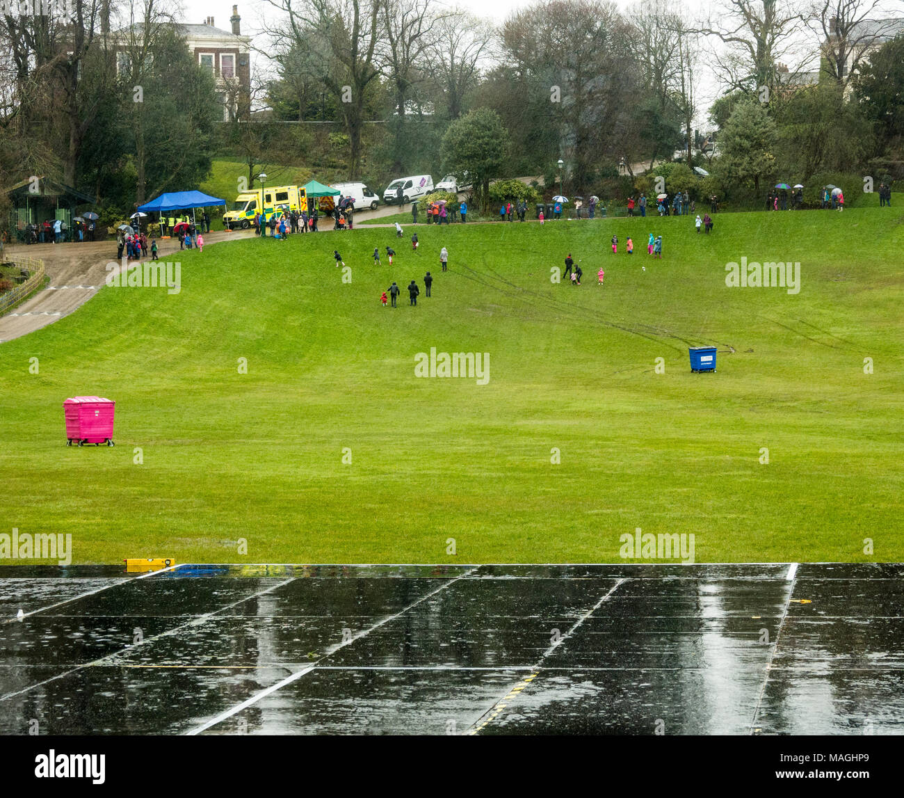 Avenham Park, Lancashire, UK, 2 April 2018. The show must go on at traditional Egg Rolling on Easyter Mondfay at Avenham Park, Preston on a very wet Easter Monday, Preston, Lancashire, UK Credit: Sue Burton/Alamy Live News Stock Photo