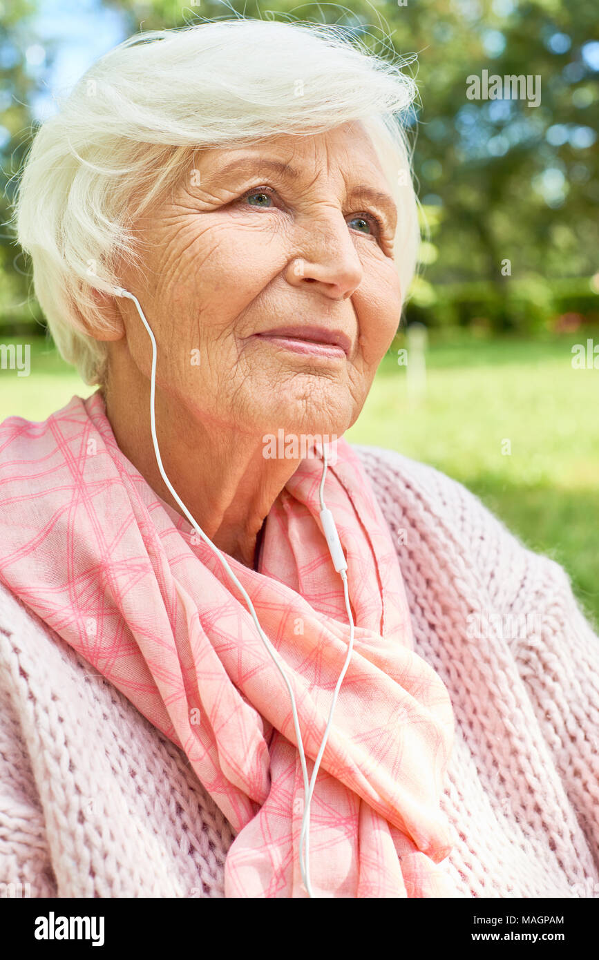 Senior Woman Listening to Music Stock Photo