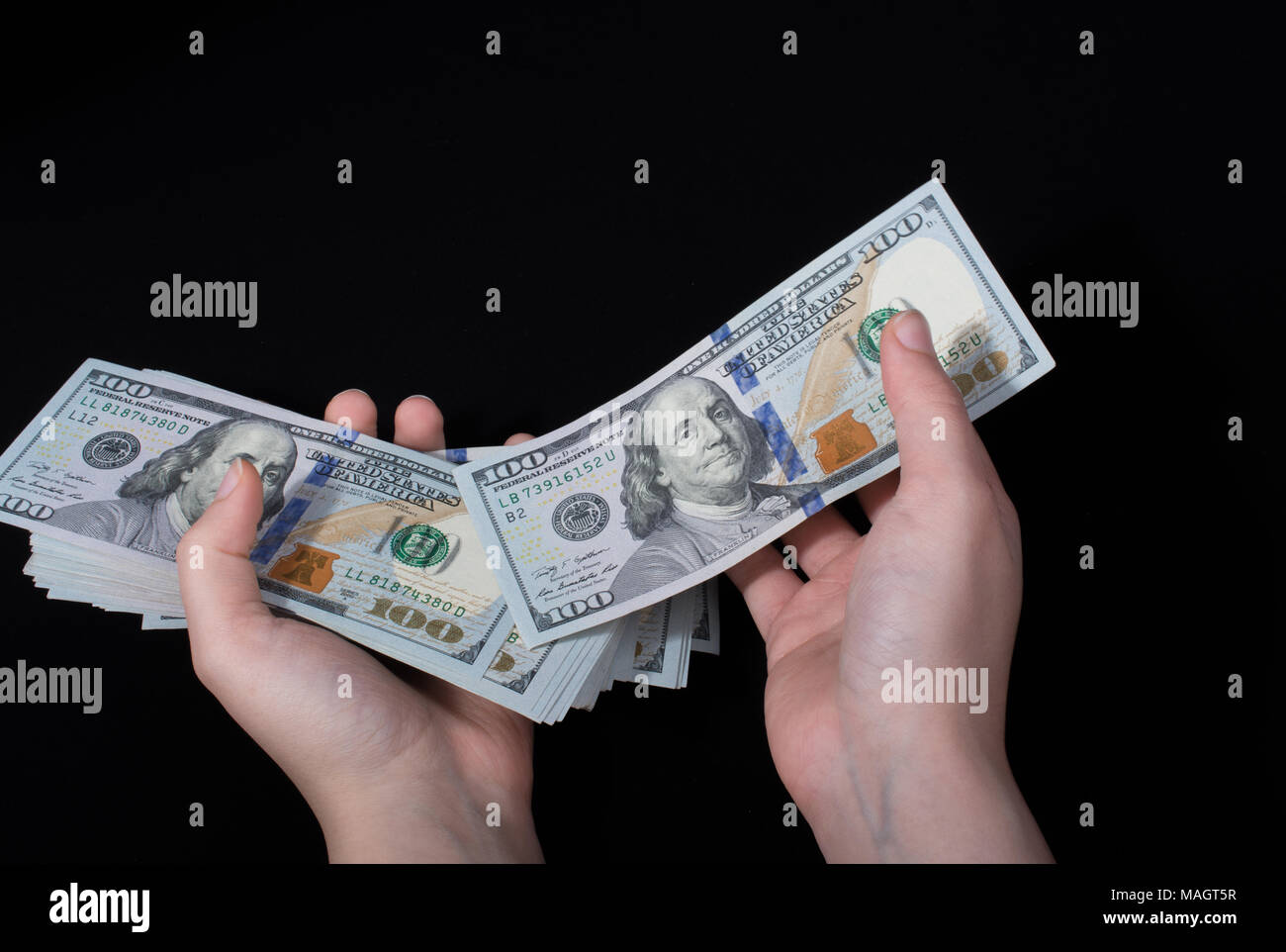 Hand holding American dollar banknotes isolated on white background ...