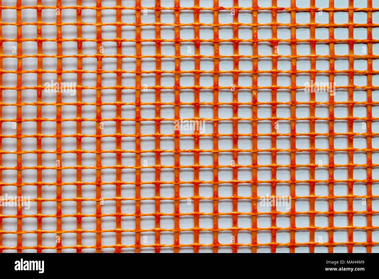 Orange plastic grid on white background surface Stock Photo
