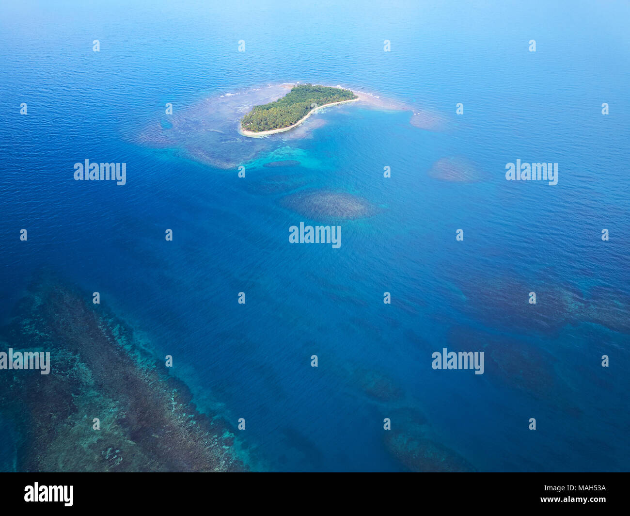 Small island in blue sea water drone aerial view. Caribbean travel destination Stock Photo