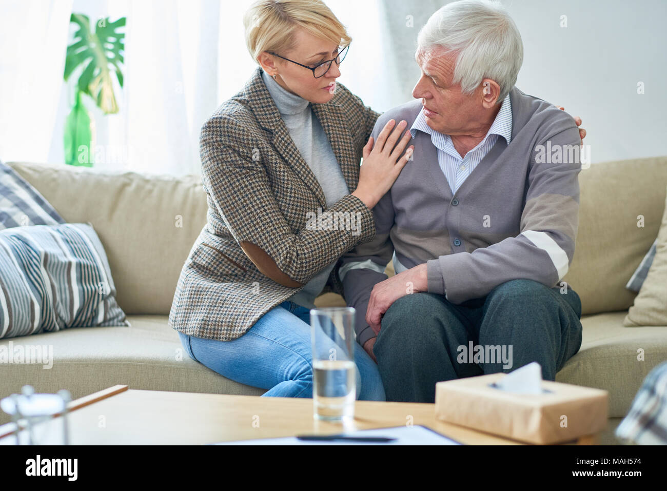 Senior Man Talking to Psychologist in Session Stock Photo