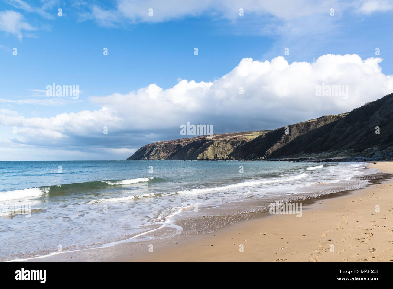 White sandy beach in Ireland with turquoise water and blue sky. This is Kinnagoe Bay in Donegal Ireland Stock Photo