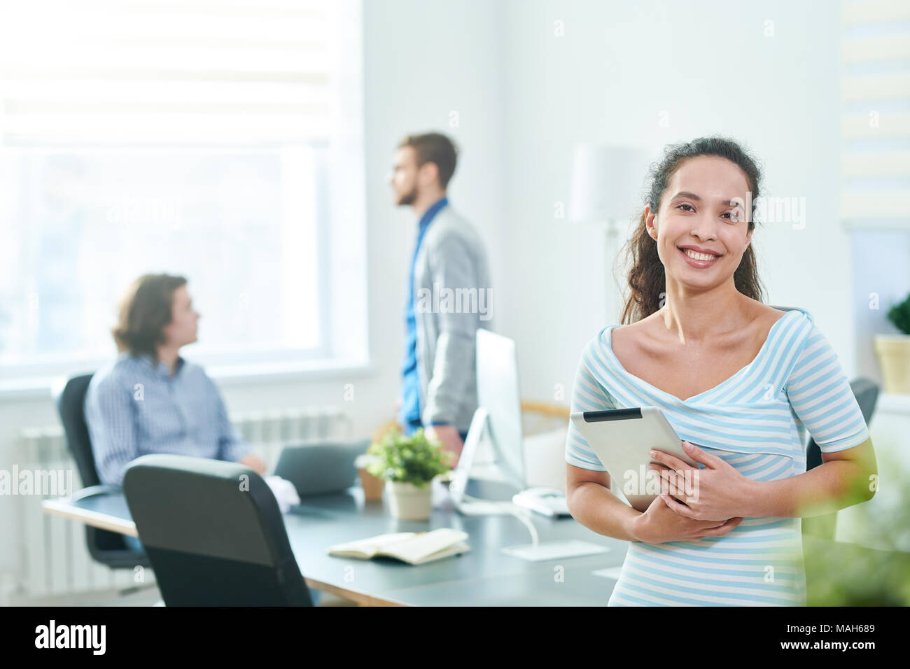 Cheerful pretty specialist with tablet Stock Photo