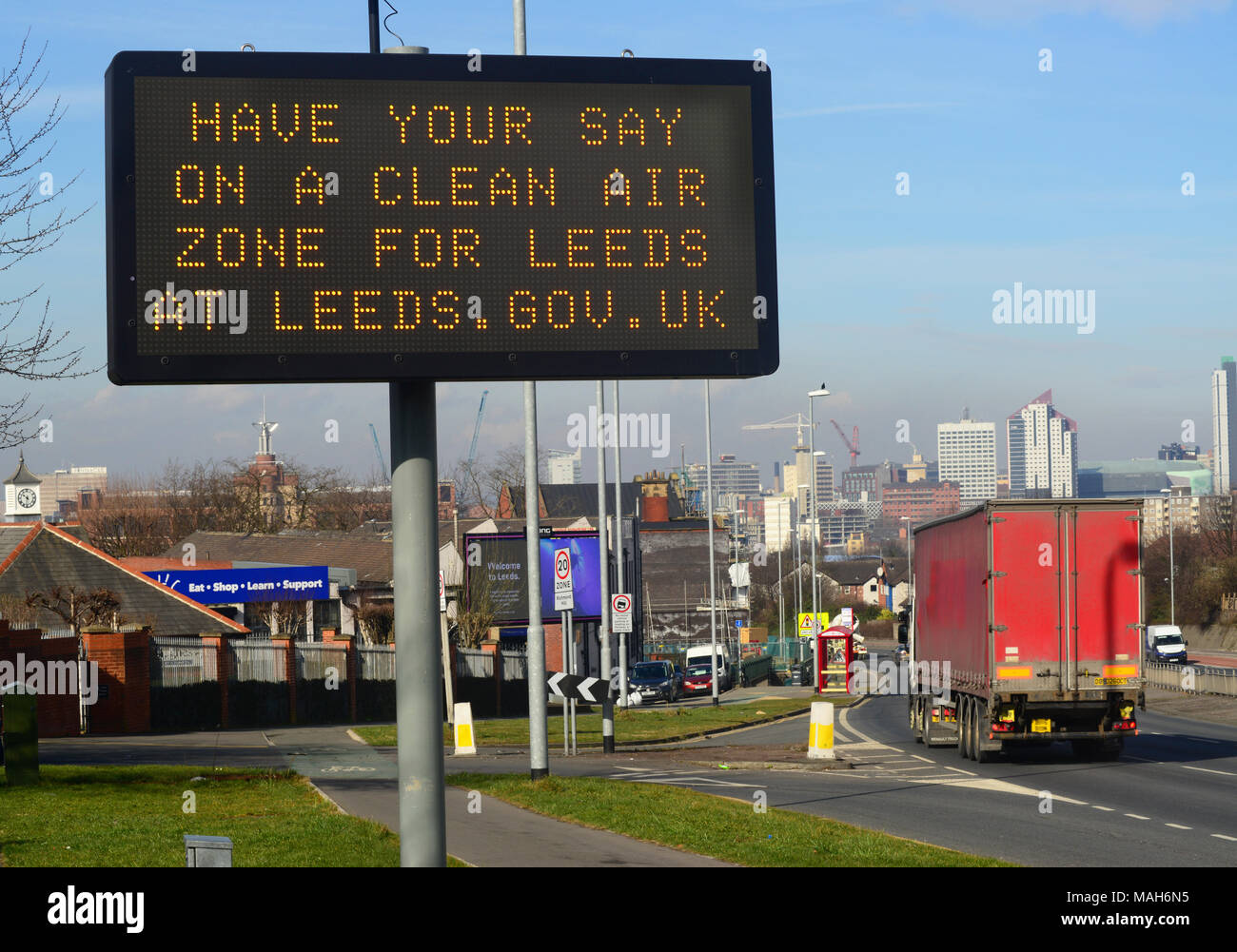 traffic passing digital advert asking for public consultation on a clean air zone for leeds city centre yorkshire united kingdom Stock Photo