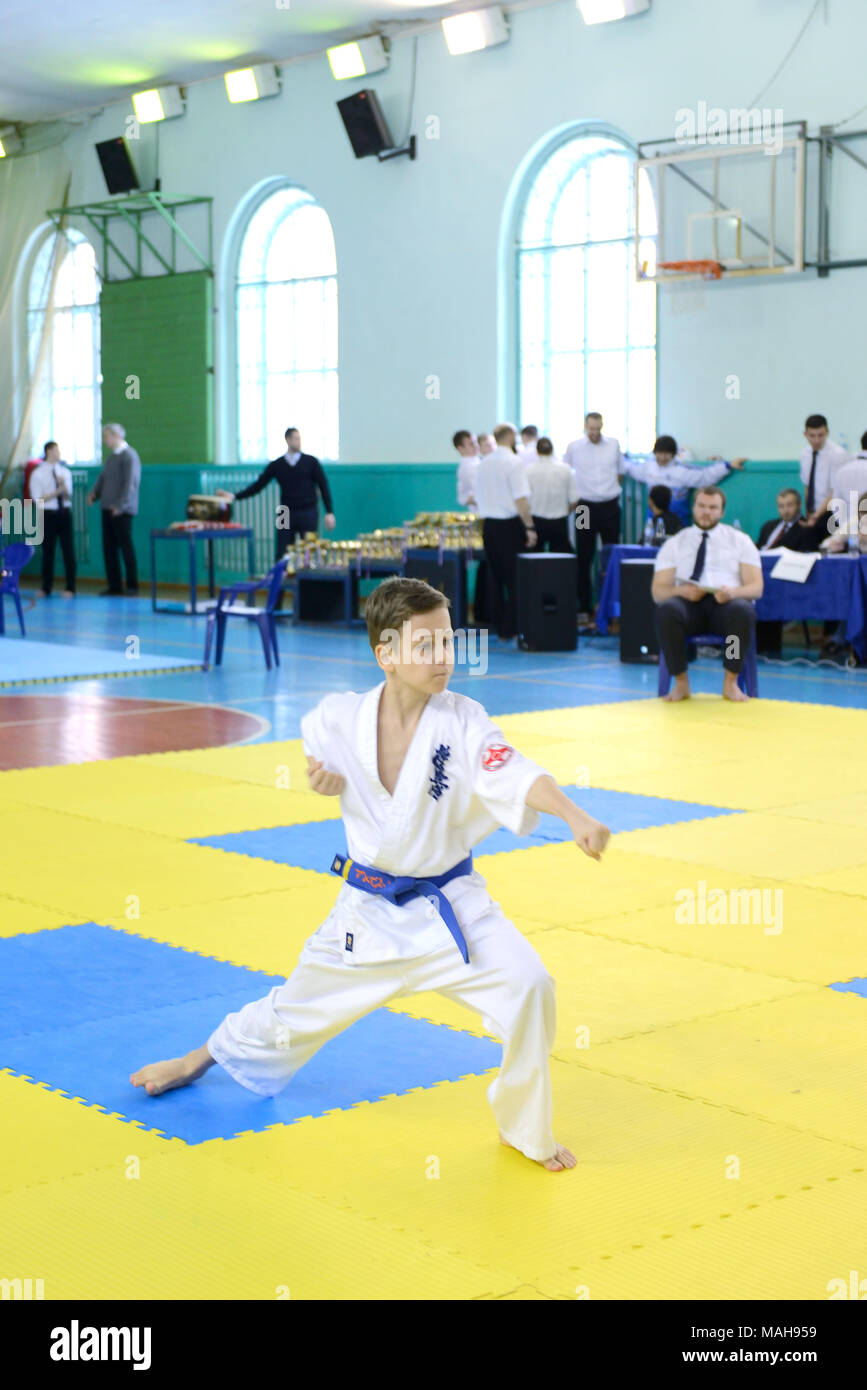 Competition among children in karate,kata.10-11 year old boy performs in karate kyokushin competitions, he does kata, zenkutsu-dati stand Stock Photo
