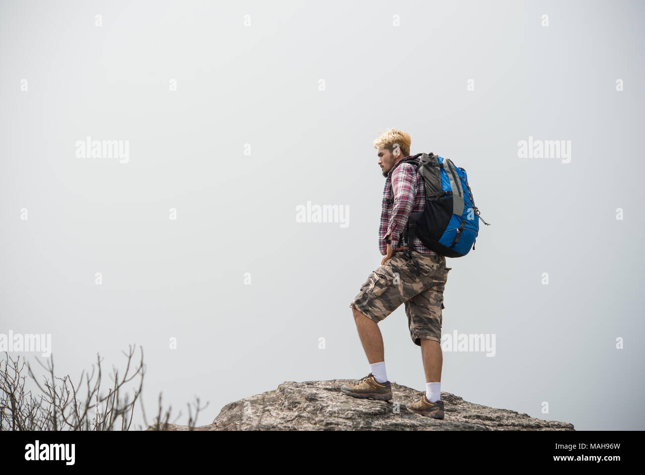 Hiker with backpacks standing on top of a mountain and enjoying nature ...