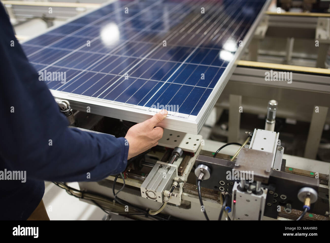 production of solar panels, man working in factory Stock Photo