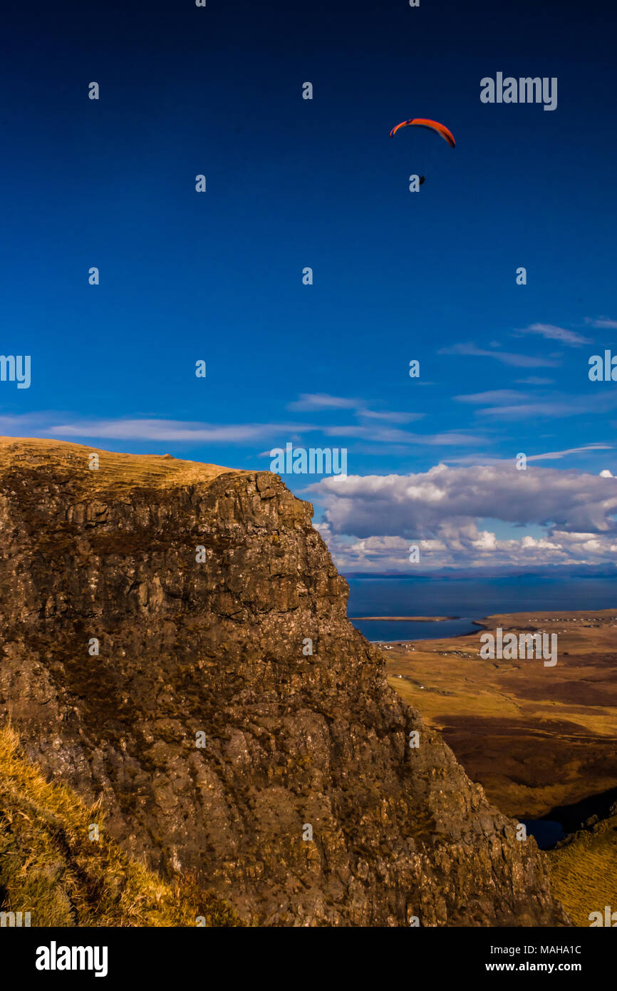 Paraglider over the cliffs of Trotternish Ridge and the Quiraing, Isle of Skye Stock Photo