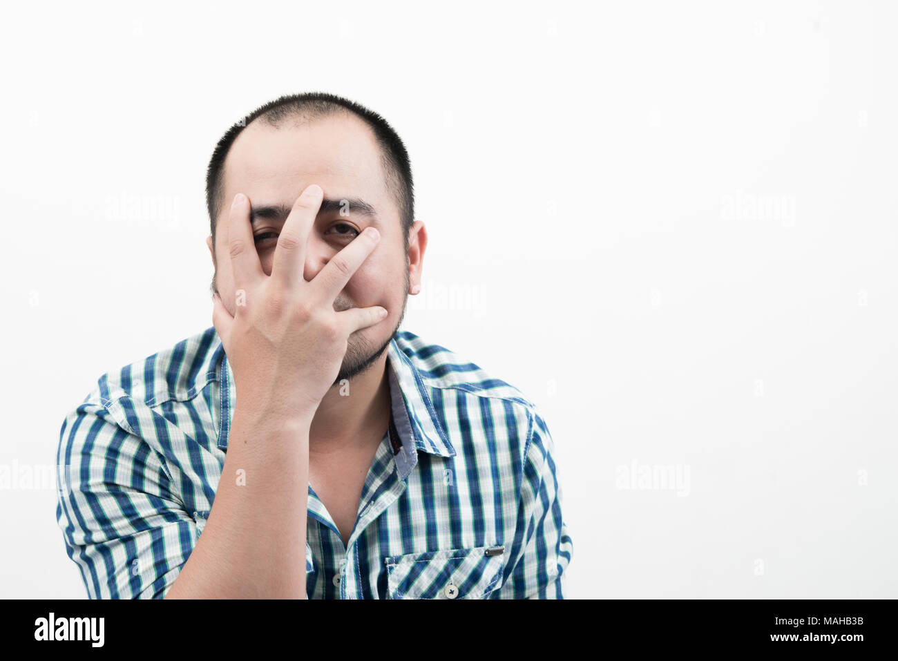 Man covering his face isolated on white background Stock Photo - Alamy