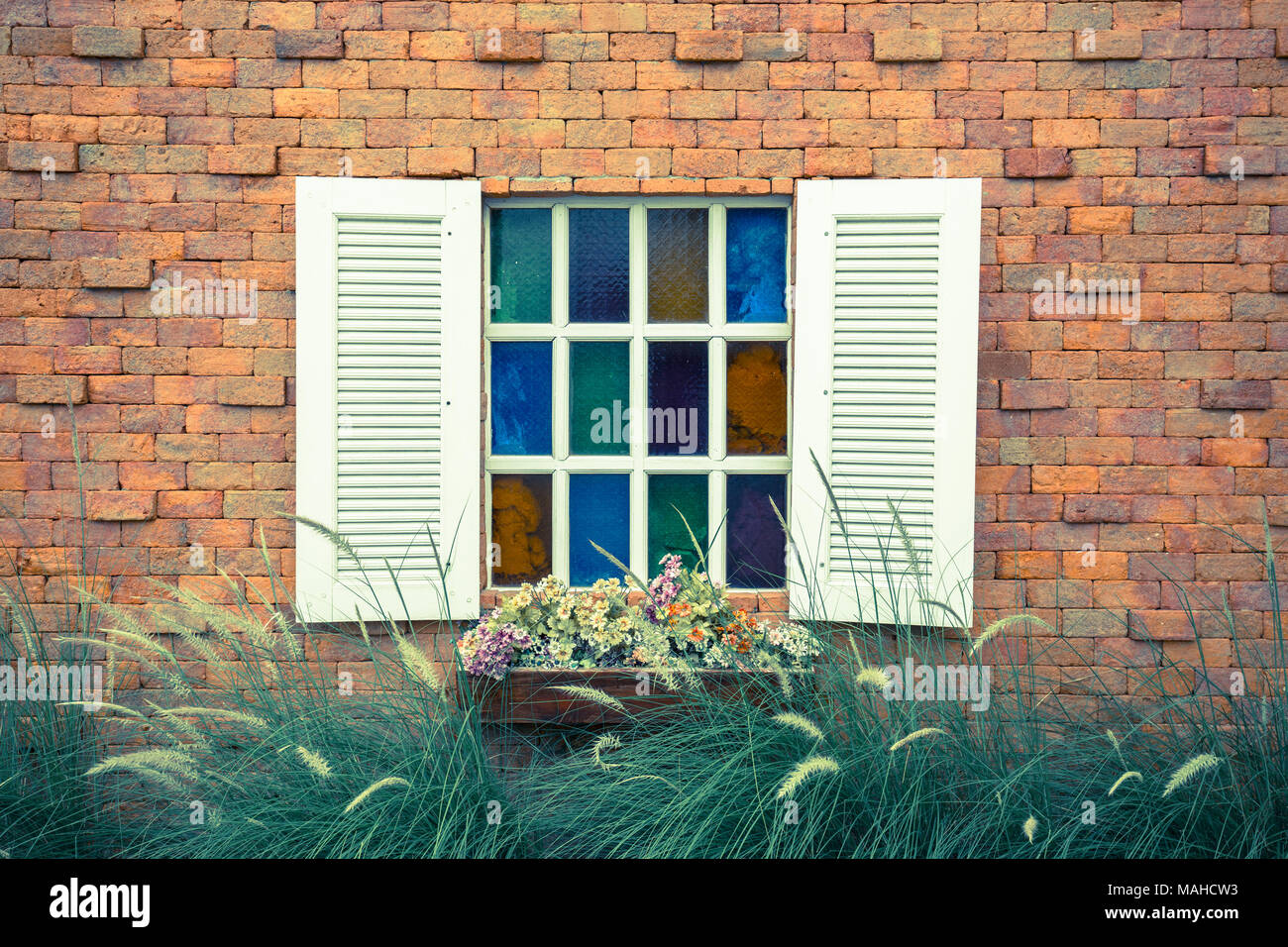 Window with flower box and brick wall Stock Photo - Alamy