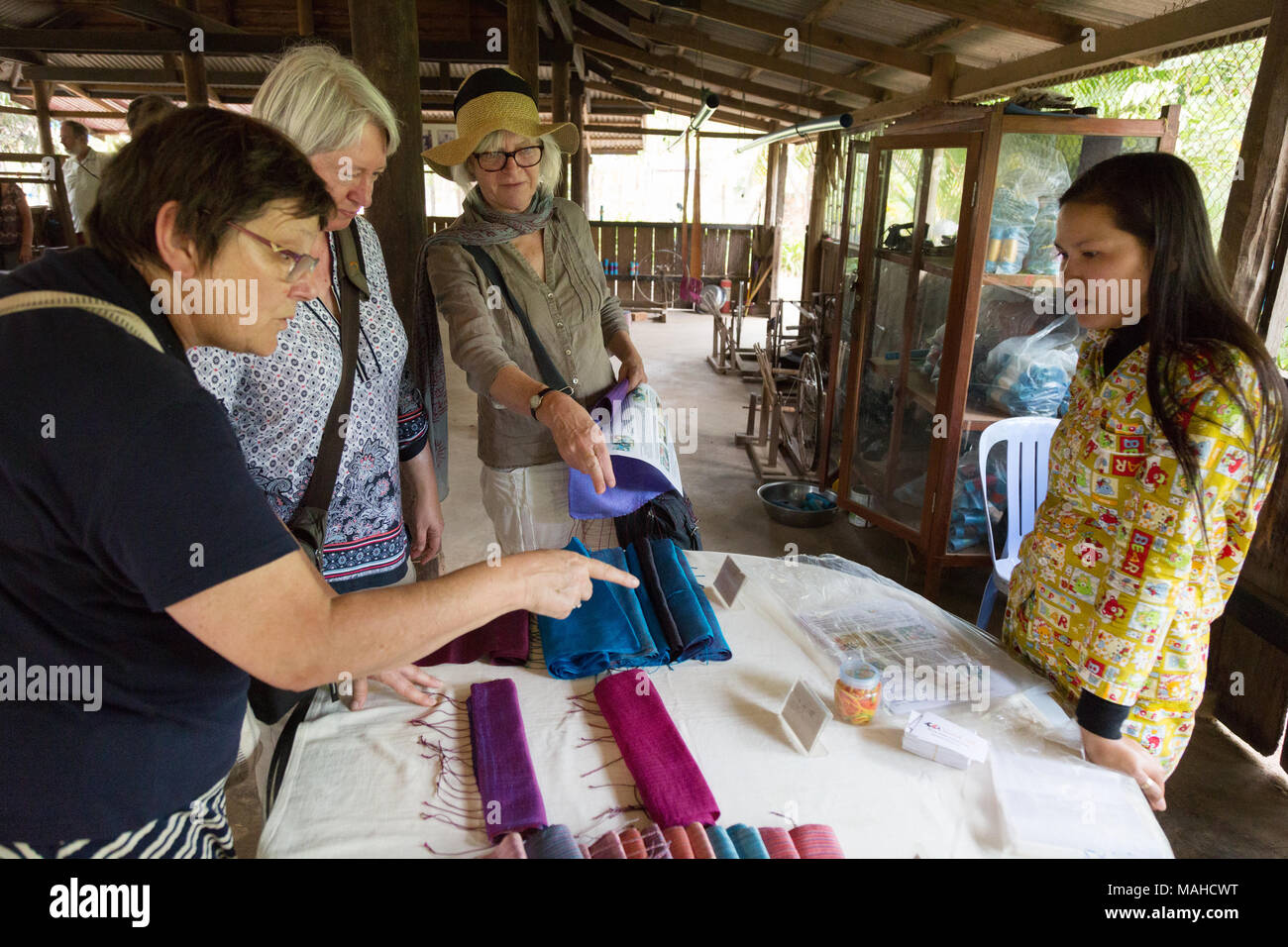 Western tourists buying silk scarves at a silk farm, Kampong Thom, Cambodia South East Asia Stock Photo