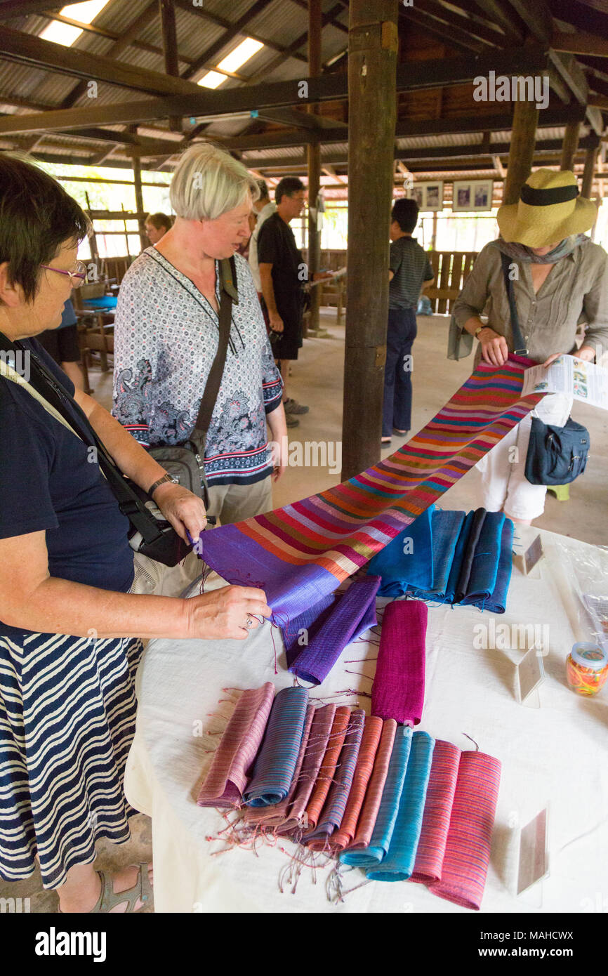 Western tourists buying silk scarves at a silk farm, Kampong Thom, Cambodia South East Asia Stock Photo