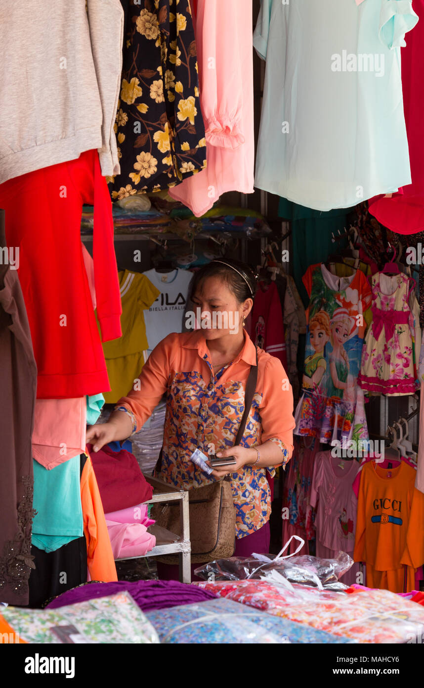Clothing Market stall and vendor, Chhlong market, Kampong Thom, Cambodia Asia Stock Photo