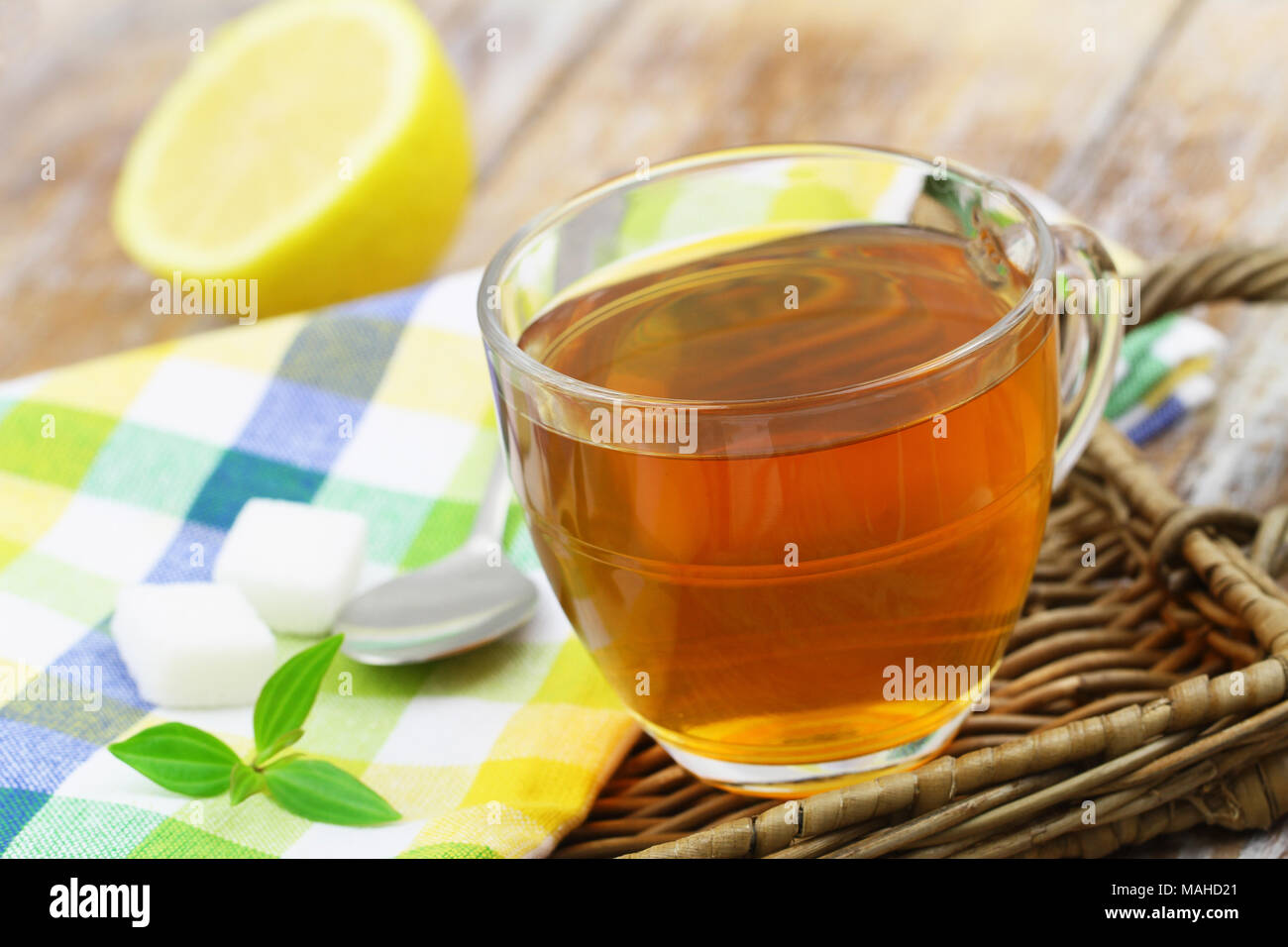 Tea in transparent glass, sugar cubes and lemon Stock Photo