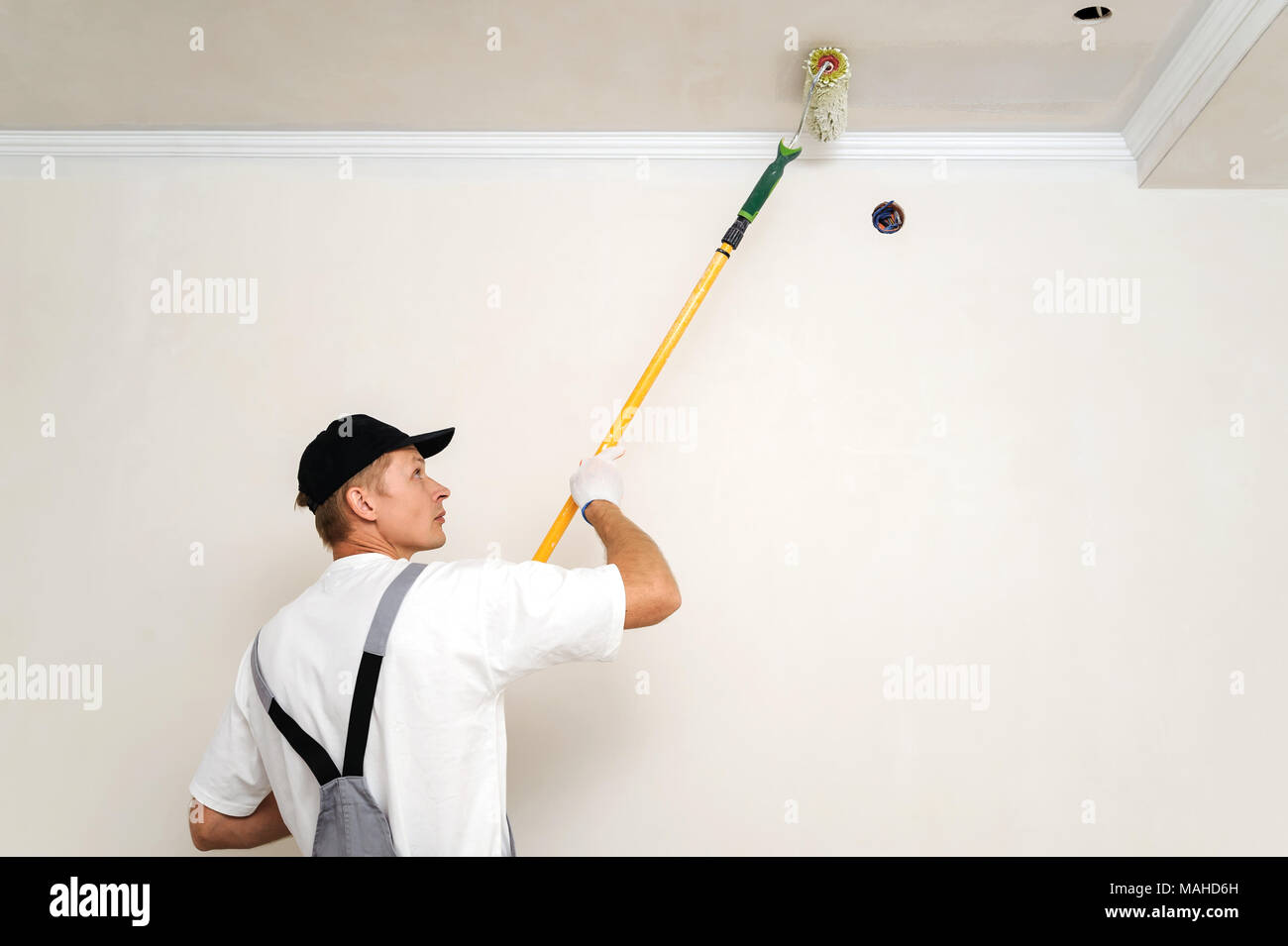 Painting Walls And Ceilings Painter Paints Using Roller Stock