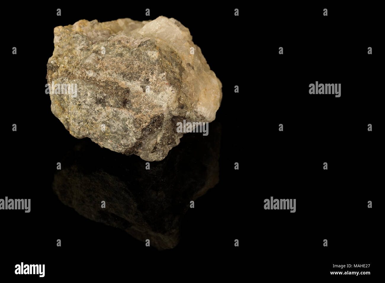 Cassiterite, tin oxide mineral, tin ore isolated on black background