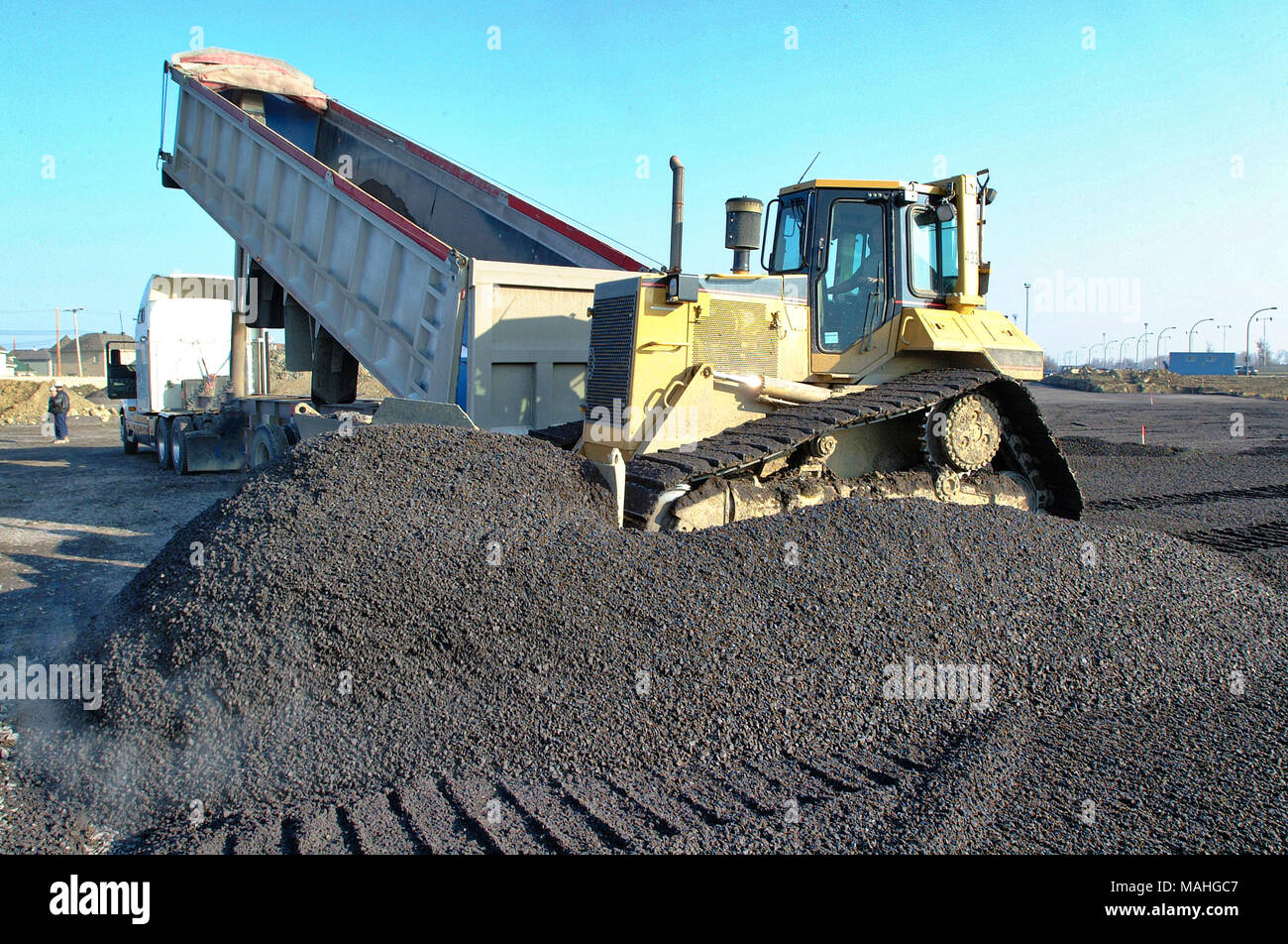A construction bulldozer moving gravel on a road building job Stock Photo