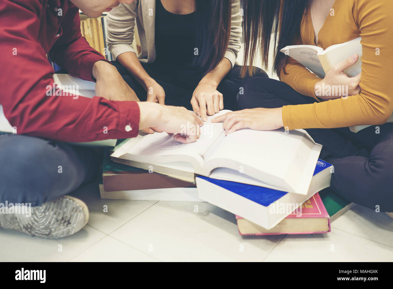 Group of happy students with books talking and preparing to exam in ...