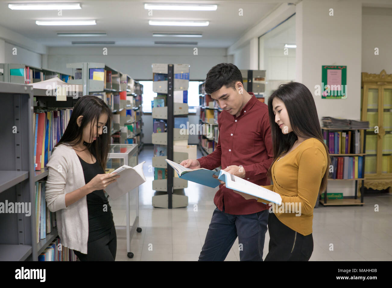 Group of happy students with books talking and preparing to exam in ...