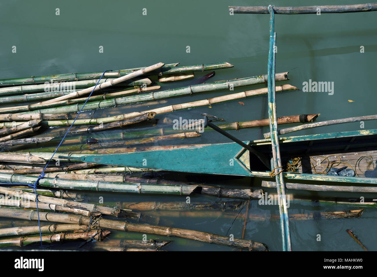 an outrigger boat used to harvest mussels parked near a group of bamboos where mussels farming in Jiabong, Western Samar, The Philippines Stock Photo