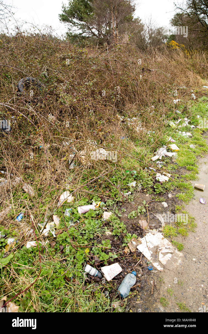Accumulated litter, tyres and plastic bottles tipped over time in a lay-by in Dorset England UK Stock Photo