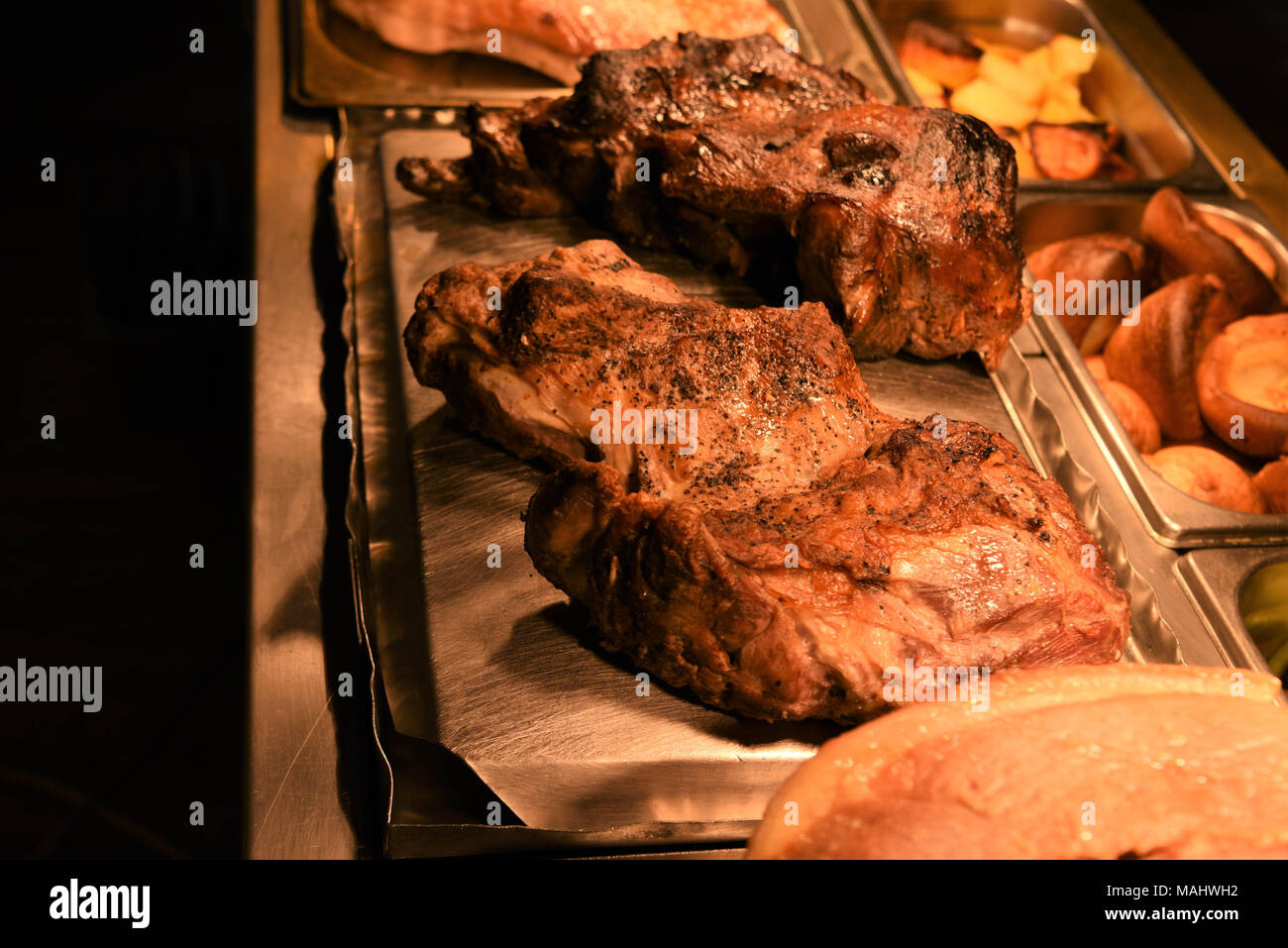 traditional roast lamb dinner with whole meats Stock Photo