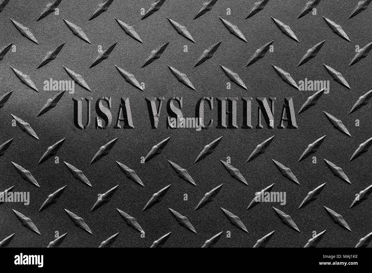 Words USA vs China written on textured steel sheet with diamond plate pattern/USA and China steel tariff dispute concept Stock Photo