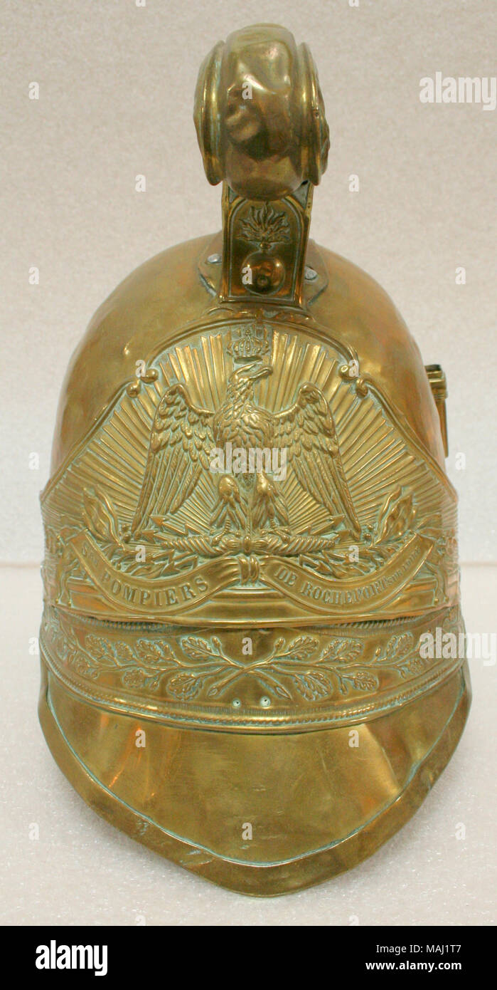 Brass fireman's helmet constructed from eight to twelve pieces riveted together from Rochefort Sur Loire Title: French Fireman's Helmet From Region of Rochefort Sur Loire  . after 1840. Stock Photo