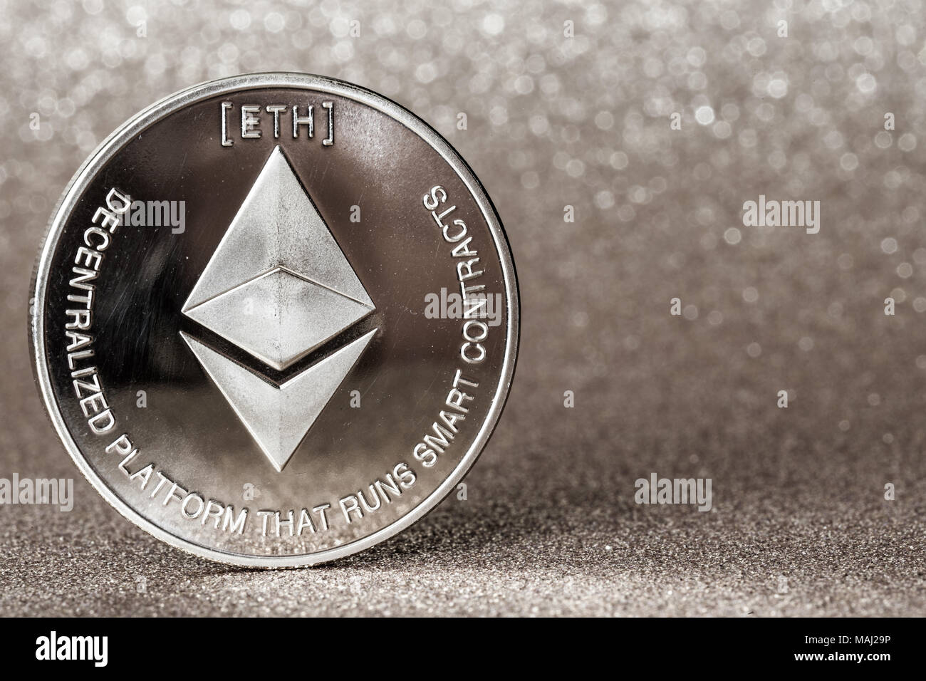 Ethereum  cryptocurrency on silver glitter background Stock Photo