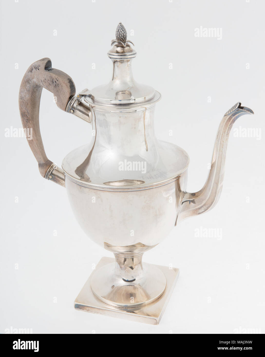 Silver coffepot with a pineapple finial on the lid and a wood handle. Made by Antoine Oneille and at one time owned by William Carr Lane, the first Mayor of St. Louis. Title: SIlver Coffeepot Made by Antoine O'Neill  . between 1803 and 1825. Oneille, Antoine, 1769-1825 Stock Photo