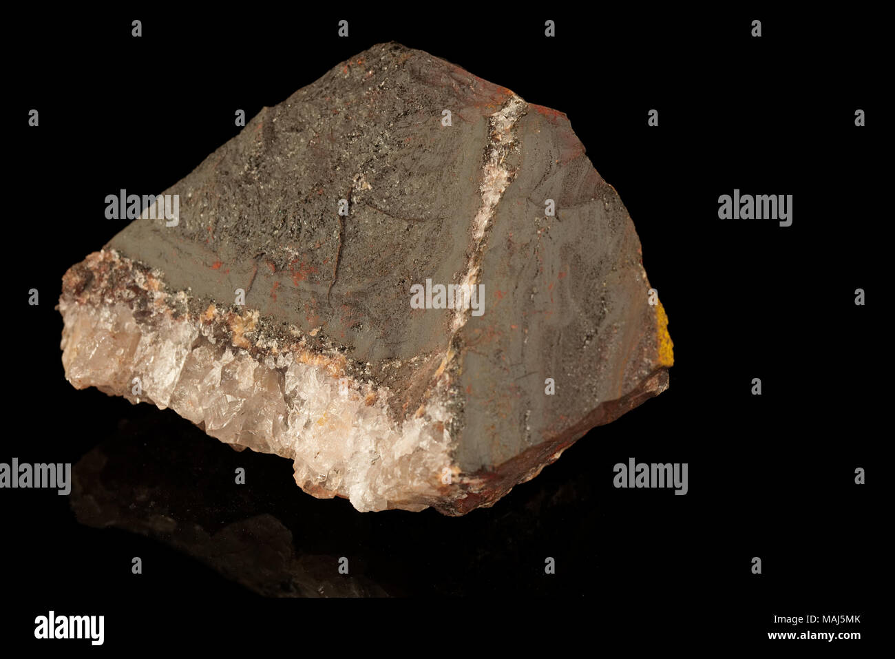 Haematite or hematite, iron ore mineral, form of iron oxide isolated on black background