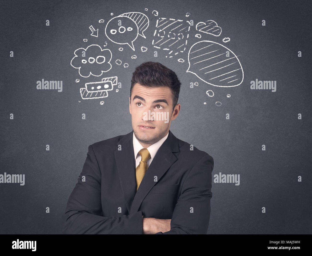 Young businessman with drawn speech bubbles over his head Stock Photo