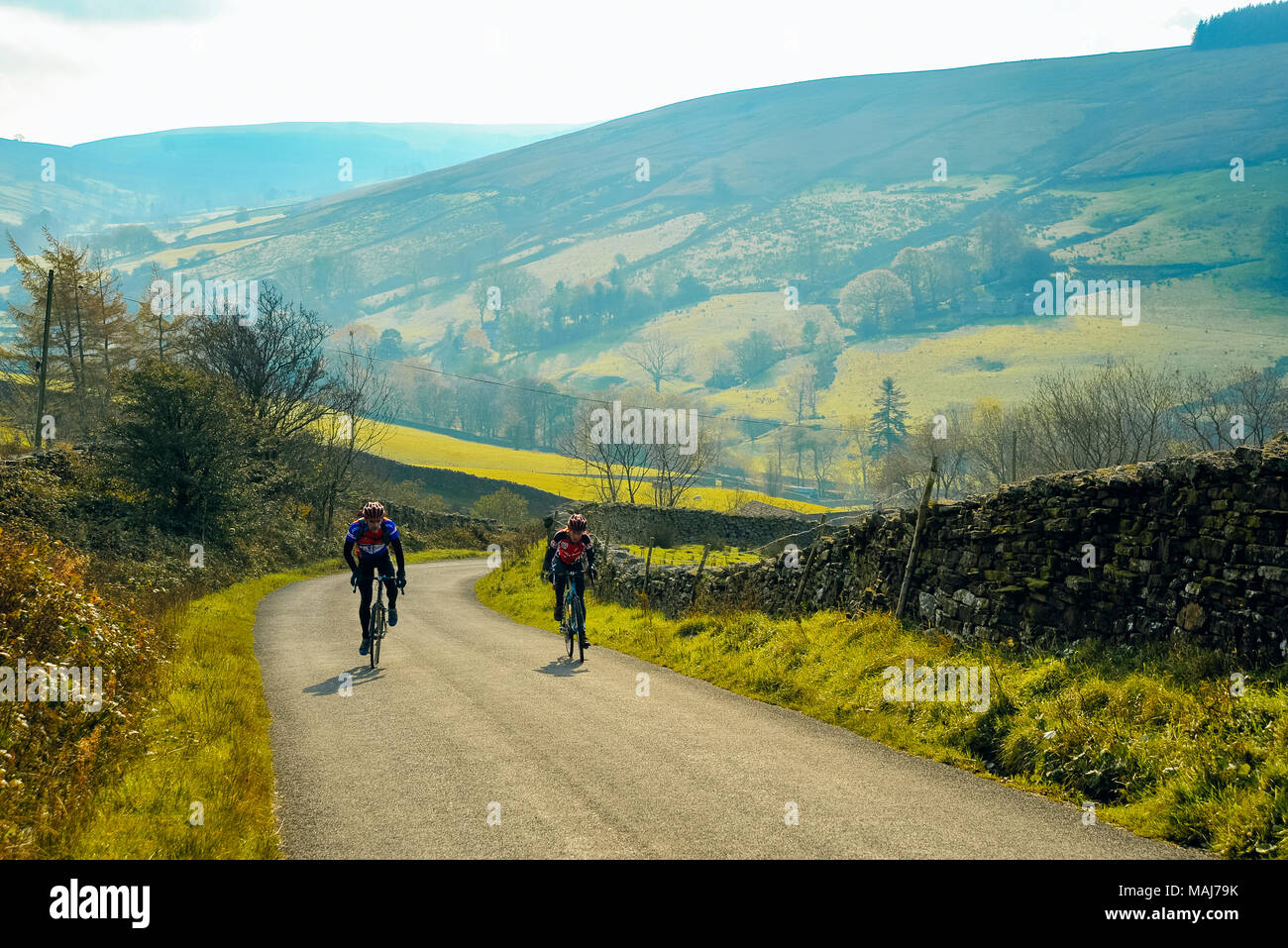 Cyclists on the climb to Dent Station above Dentdale in the Yorkshire Dales National Park Stock Photo