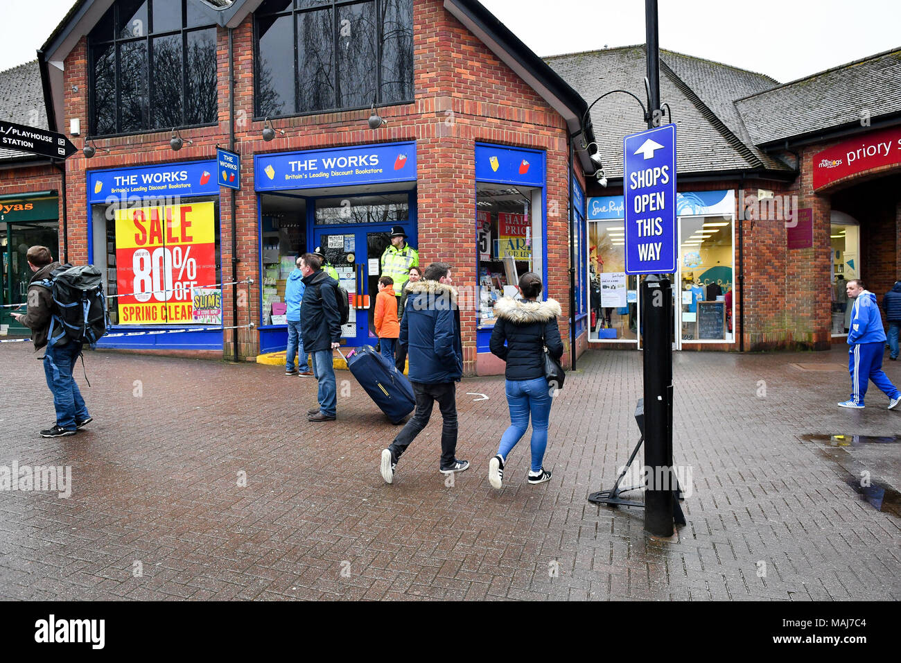 Shoppers walk past the police cordon in the Maltings area that is still cordoned off due to the poisoning attack. Stock Photo