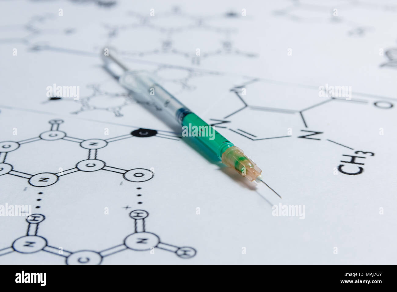 Concept of Non-natural Products, Gmo. Syringe on White Background with Chemical Formula, Stock Photo