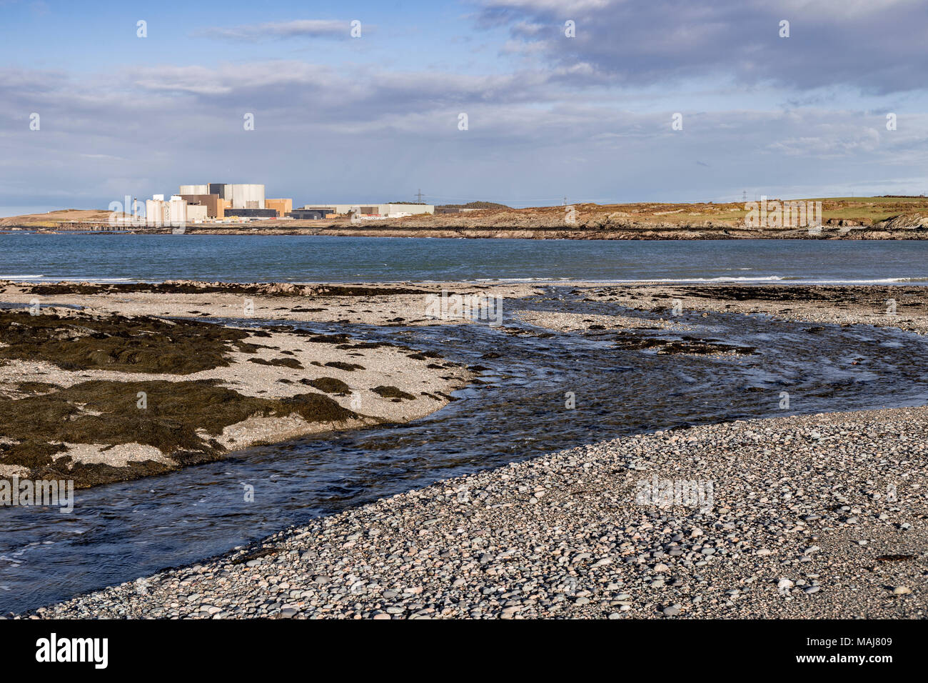 Wylfa nuclear power station on the Anglesey coast, North Wales, as seen from Cemlyn nature reserve Stock Photo