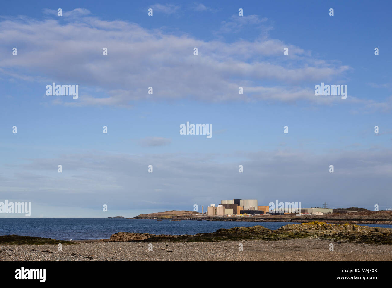 Wylfa nuclear power station on the Anglesey coast, North Wales, as seen from Cemlyn nature reserve Stock Photo