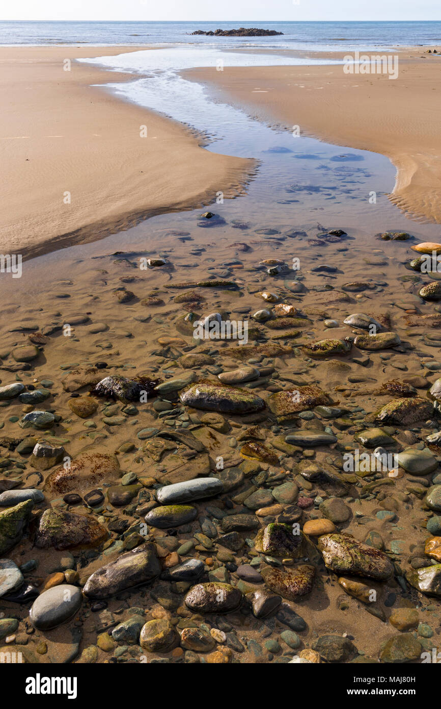 Stream on the beach at Porth Trwyn, Anglesey, North Wales Stock Photo