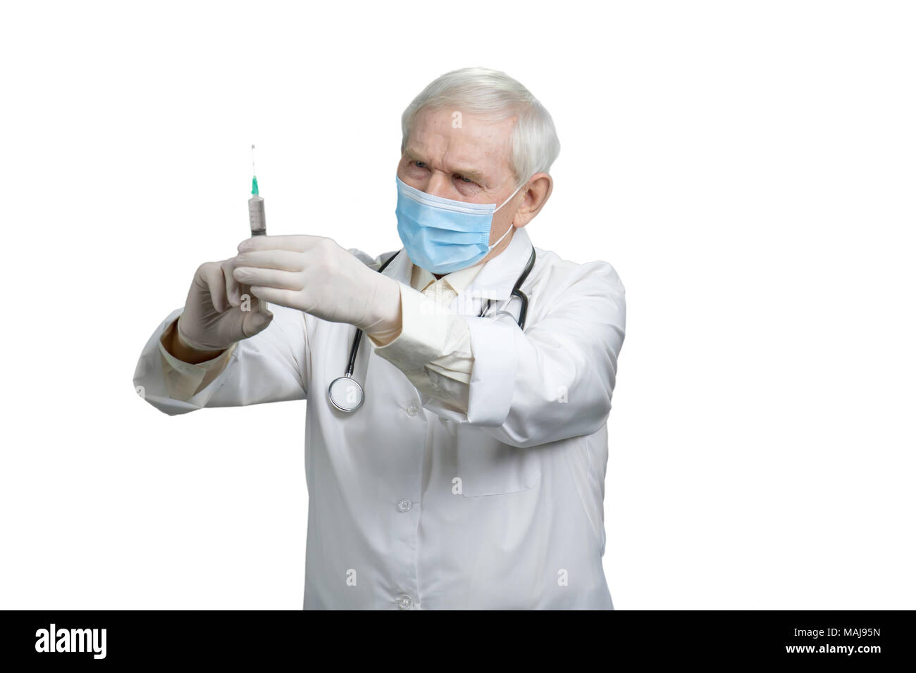 Senior doctor preparing syringe for injection. Smart professional ...