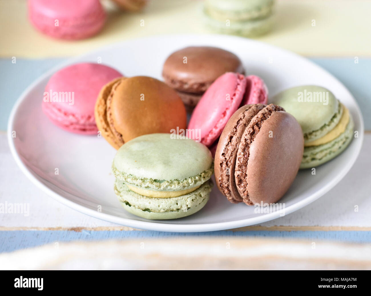 Delicious macaroons or macaron biscuits on a tablet. Coffee break scene