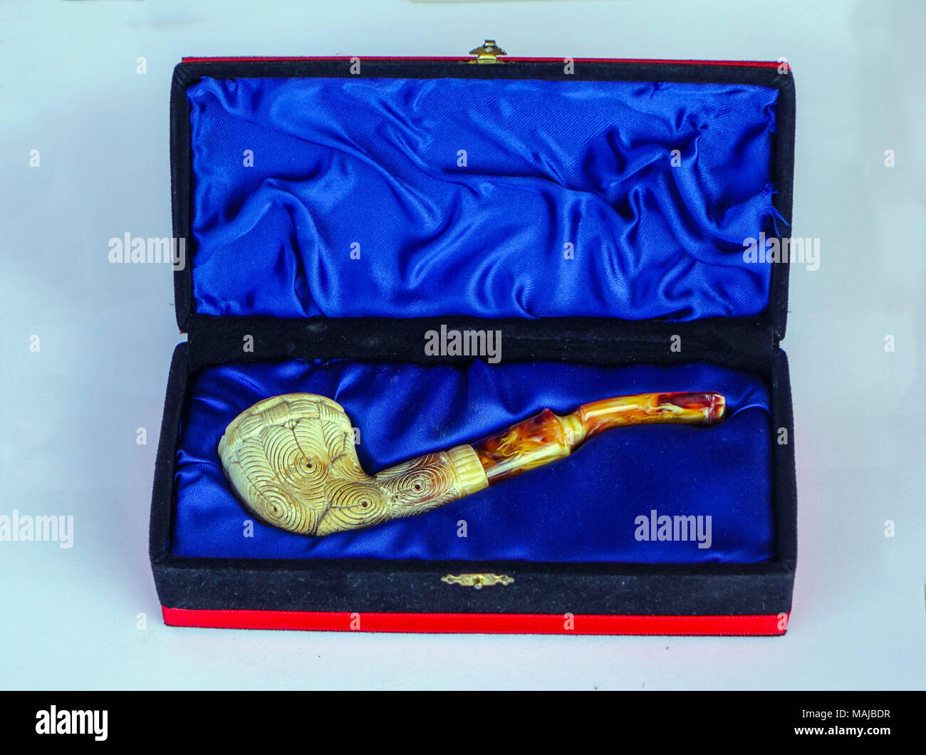 Ornate Meerschaum smoking pipe in decorative case against white background, in Turkey Stock