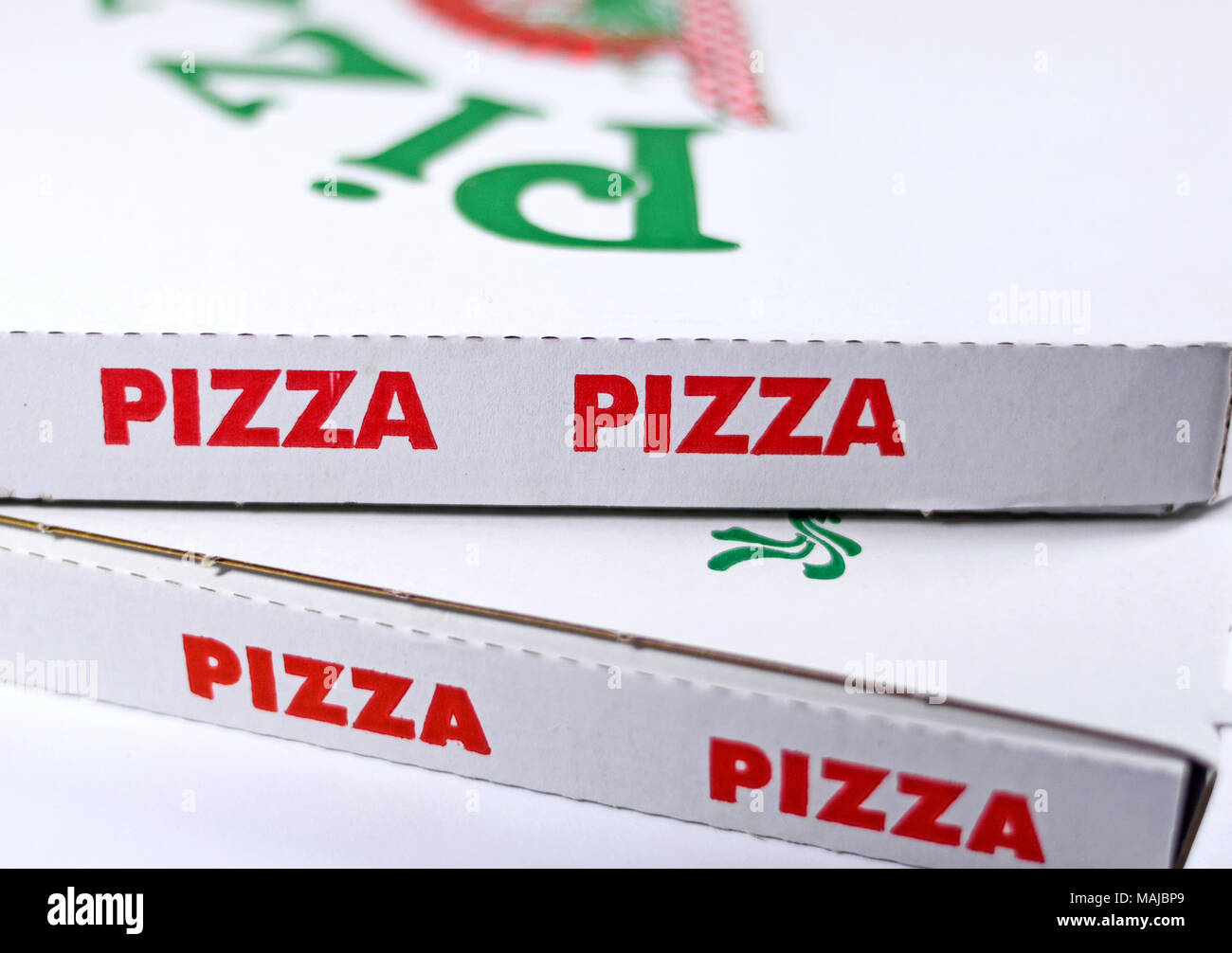 Pizza boxes or delivery boxes, isolated on white background. Pizza package, close-up shot. Stock Photo