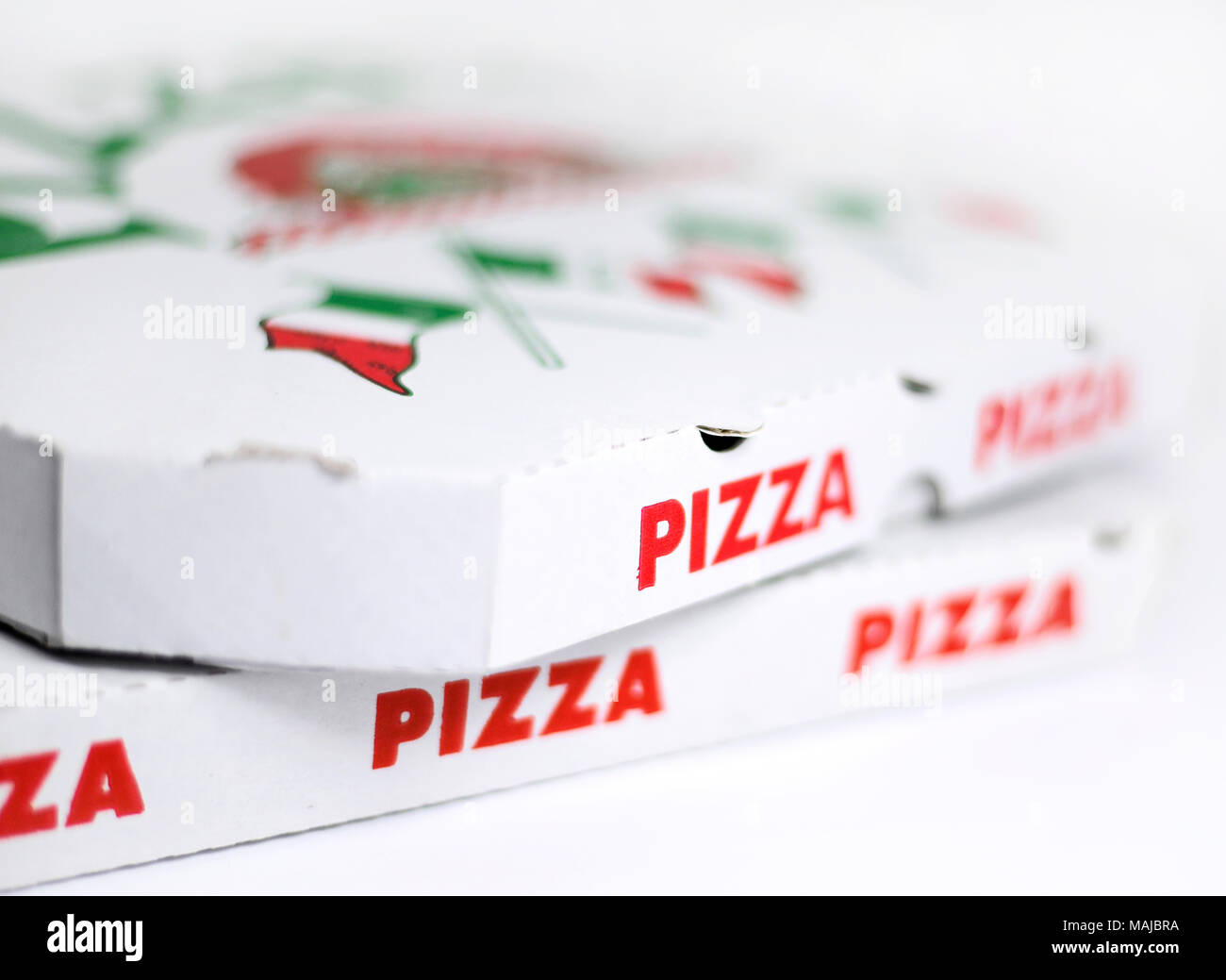 Pizza boxes or delivery boxes, isolated on white background. Pizza package, close-up shot. Stock Photo