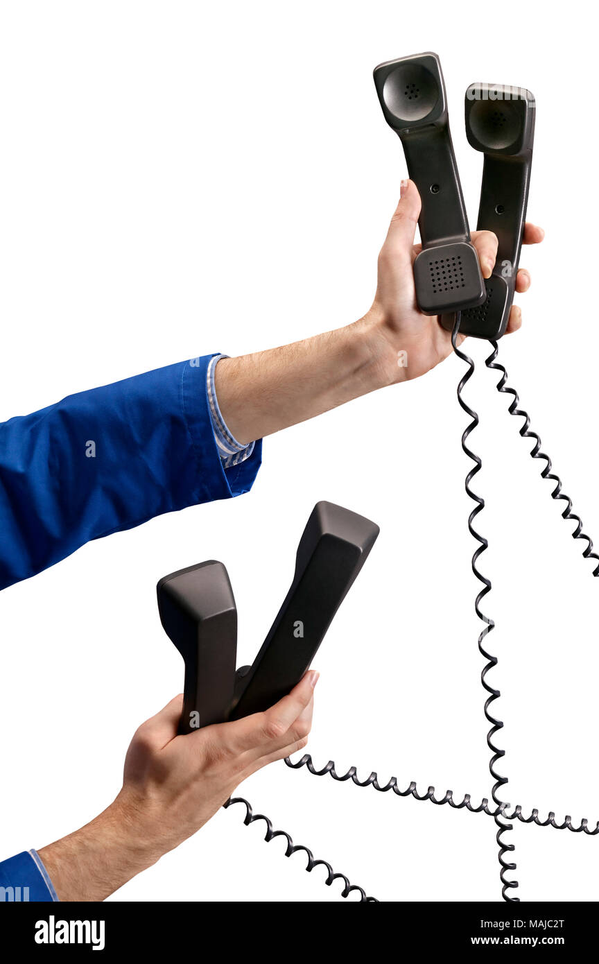Person holding multiple classic old phones as in multi tasking Stock Photo