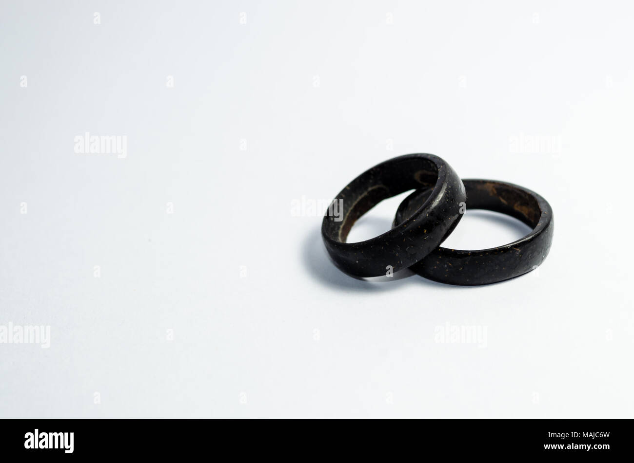 pair of coconut rings together on a white background. Intense black tone. Handicraft common in the northeast of Brazil. indigenous ring. Tucum ring. Stock Photo