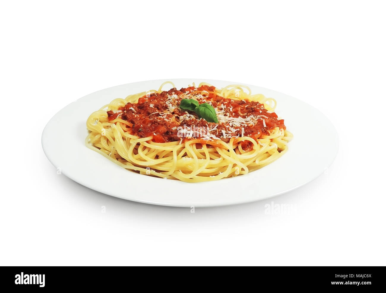 Spaghetti bolognese on a white plate with basil leaf, isolated on white background. Italian cuisine, traditional food. Stock Photo