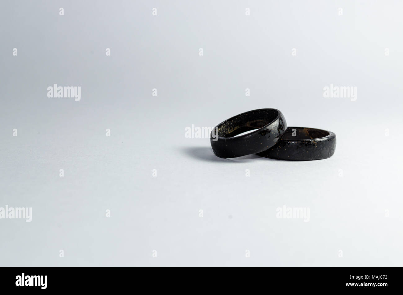 pair of coconut rings together on a white background. Intense black tone. Handicraft common in the northeast of Brazil. indigenous ring. Tucum ring. Stock Photo