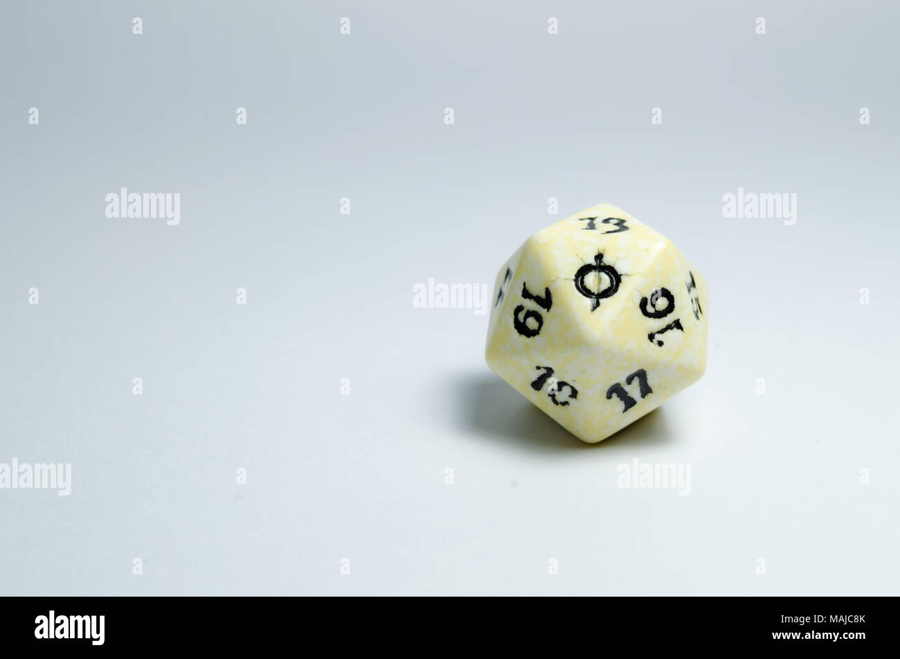 twenty-sided dice, isolated on a white background. symbol in focus. dice of role playing game Stock Photo